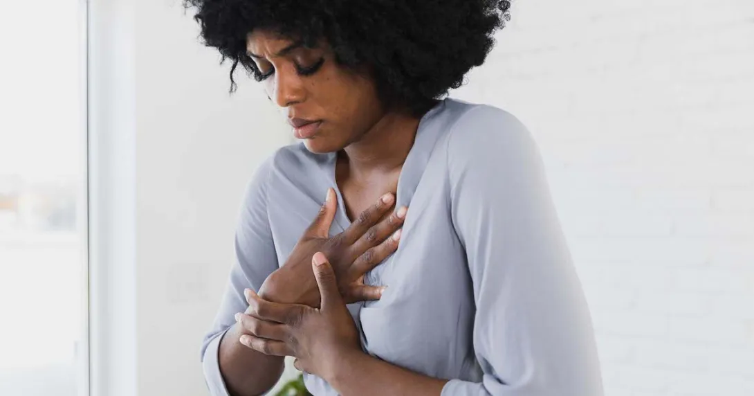 Person holding their chest
Person holding their chest