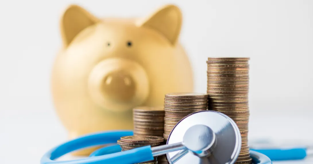 
  A piggy bank with a stethoscope and a pile of coins.
