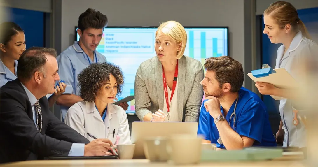 
  Businesspeople and doctors in a meeting together.

