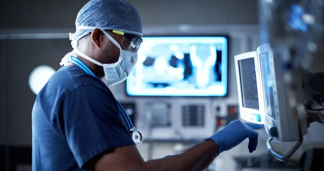 Healthcare provider in scrubs looking at computer screens Healthcare provider in scrubs looking at computer screens