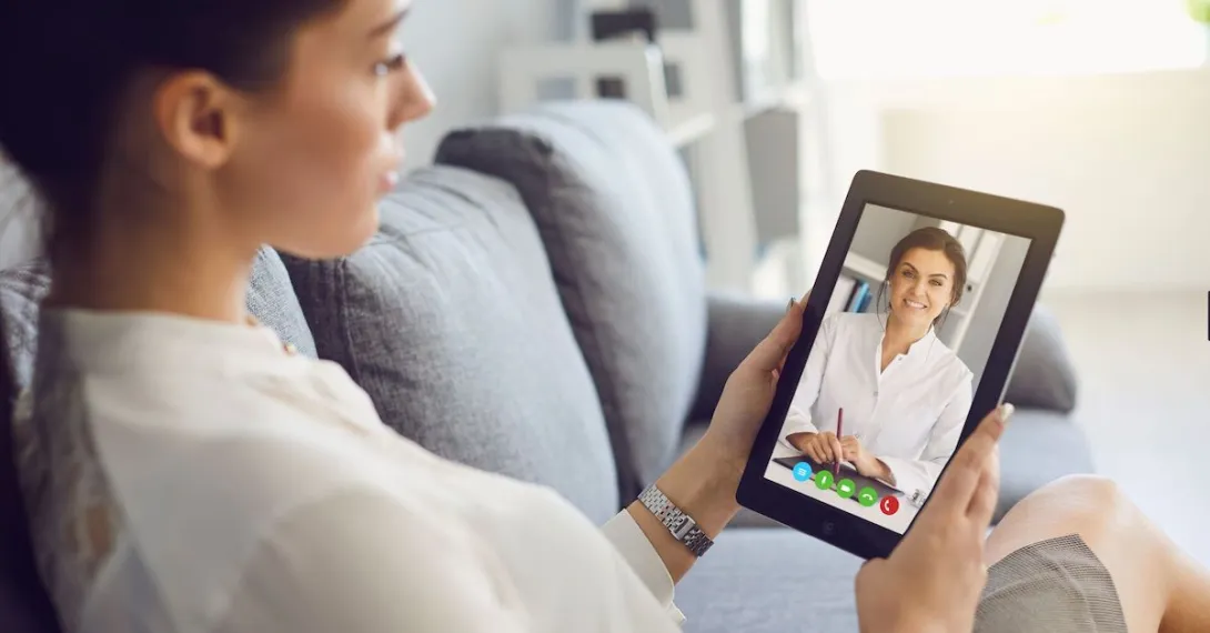 A person talks with a provider using a tablet