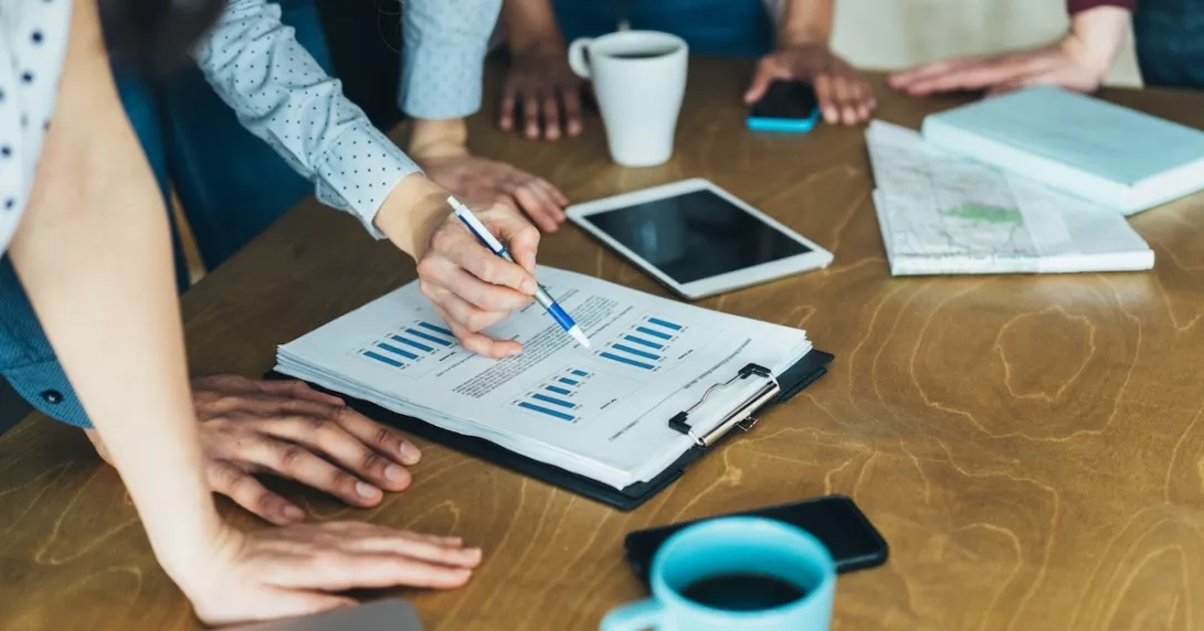 Photo of people reviewing data/charts/graphs Photo of people reviewing data/charts/graphs